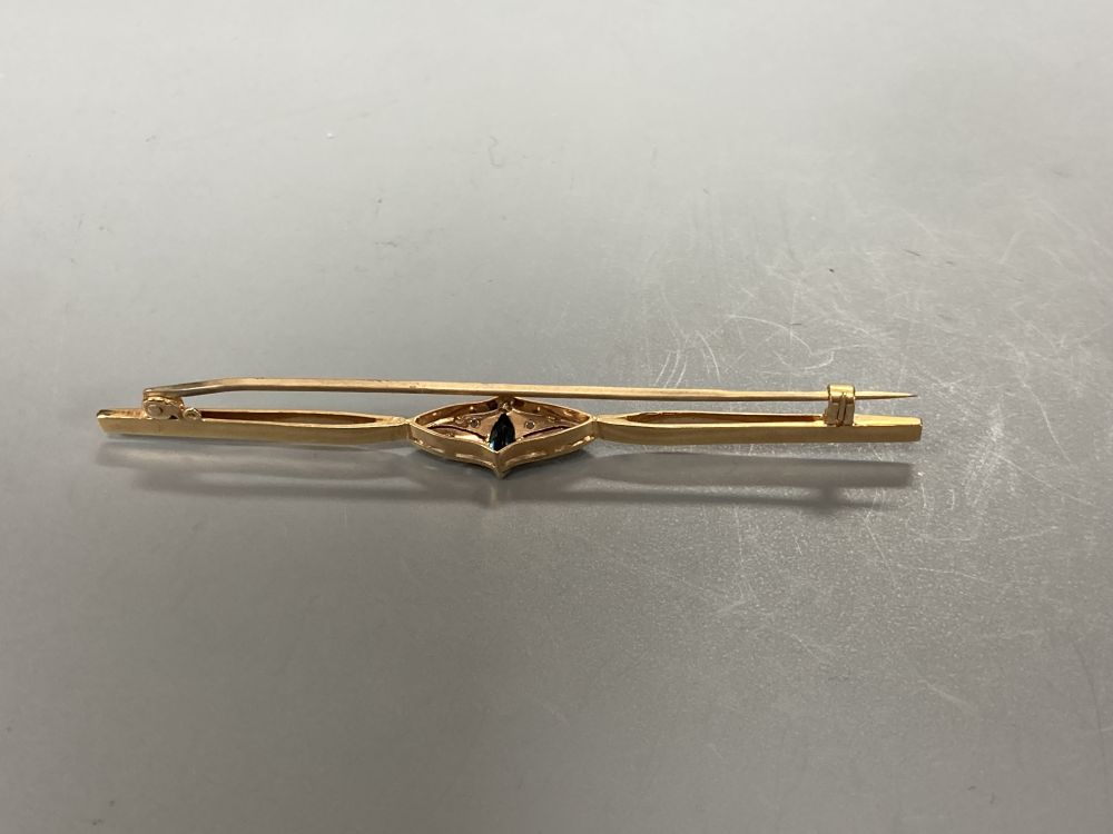 A Victorian 15ct gold, garnet and seed pearl cluster dress ring, size N, gross 1.8 grams, another ring and a bar brooch.